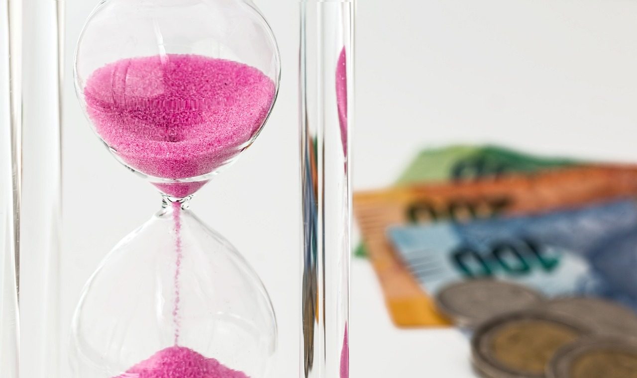 hourglass with some money