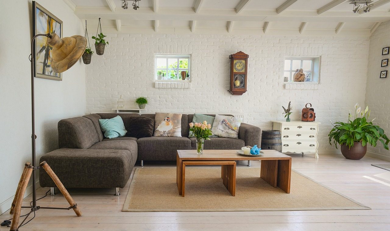 Livingroom with grey sofa and table with indoor plants
