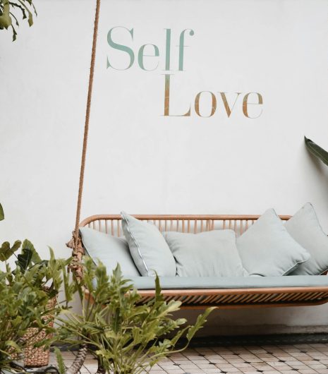 brown rattan swing bench with cushions